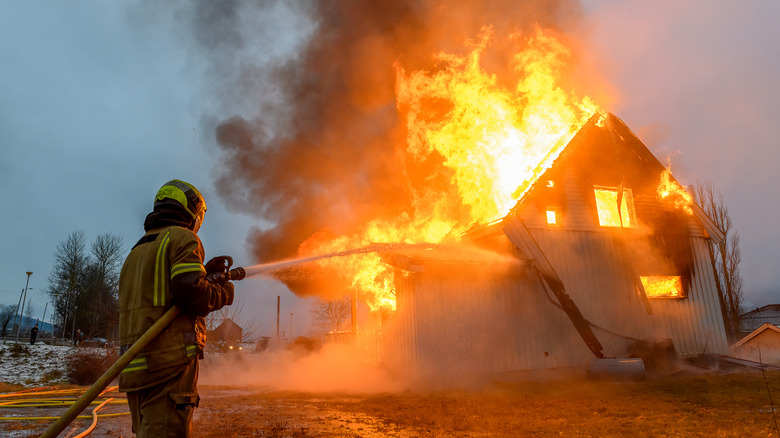 firefighter putting off house fire