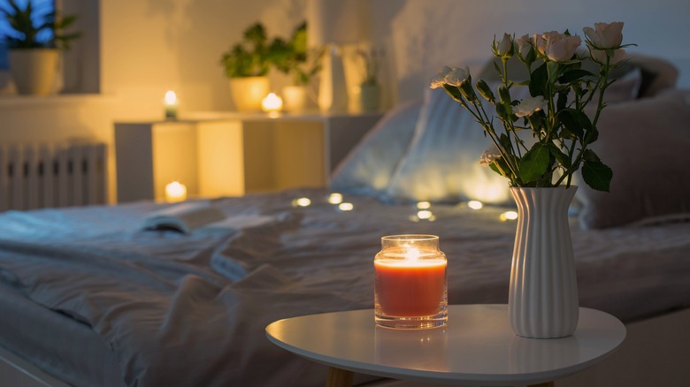 Candlelit bedroom with flower vase