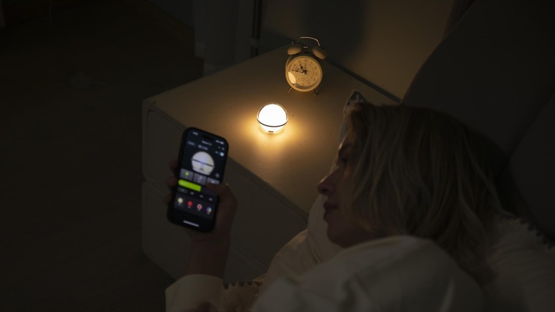 Olight Sphere C glowing on a nightstand