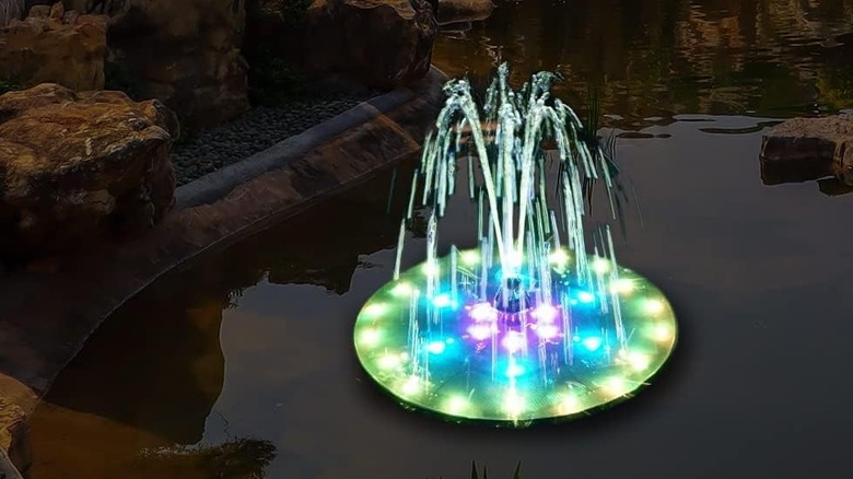 A Gaizerl solar fountain in a bird bath with the lights turned on.