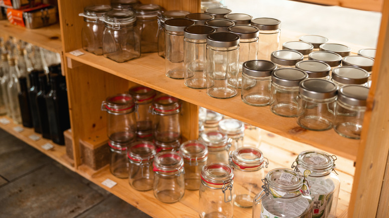 Shelves full of empty glass jars.