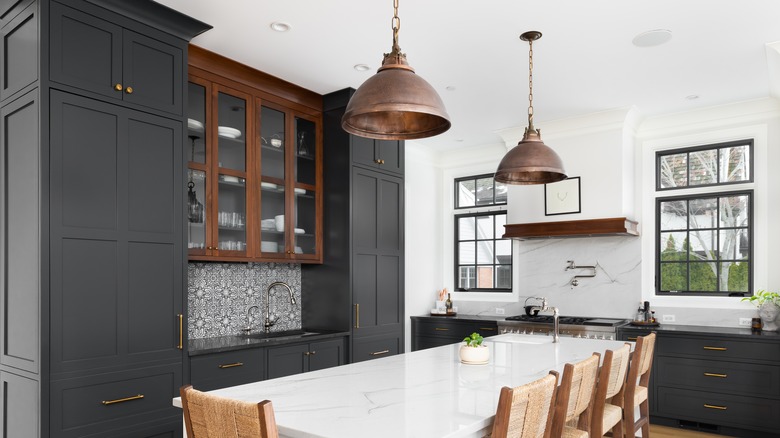 Dining area with bronze pendant lighting