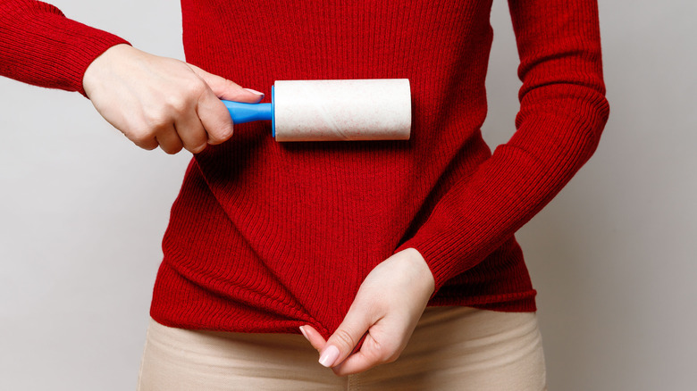 using lint roller on sweater