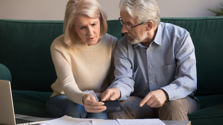 older couple calculating paperwork 