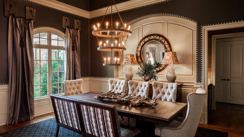 A stately traditional dining room with a table and seats for eight