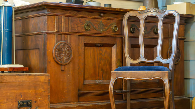 A vintage chair, buffer and chest in a workshop