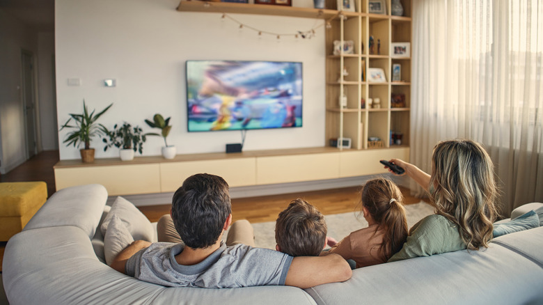Parents and their children watching TV together