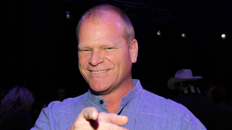 Mike Holmes smiling and pointing at the camera.