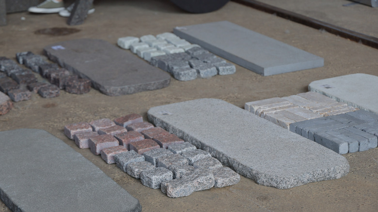 Variety of natural stone pavers including granite and travertine