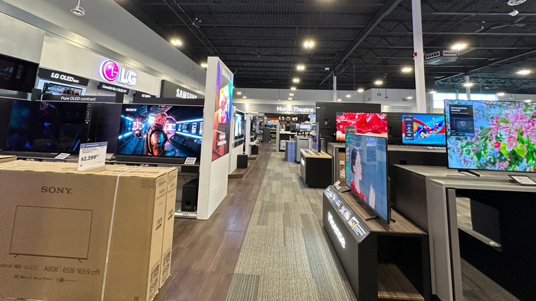 A Best Buy store full of TVs for sale.