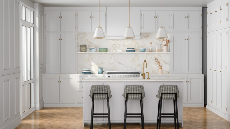 Clean neutral white kitchen with gold accents
