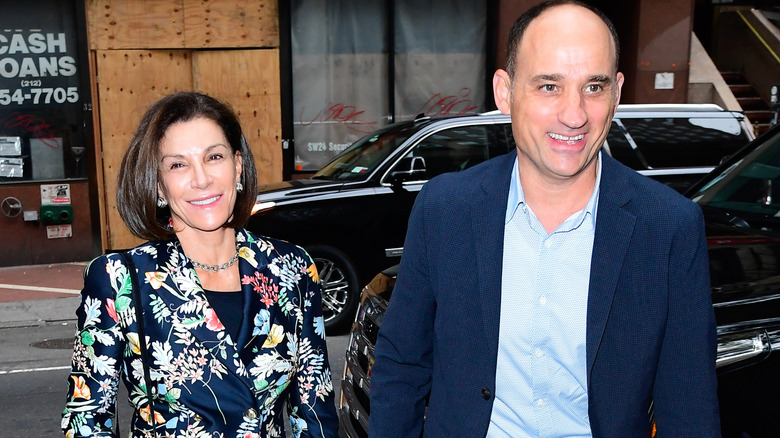 Hilary Farr in a floral jacket walking with David Visentin in a blue jacket