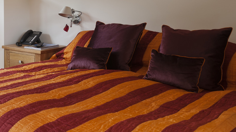 Maroon and orange striped bedding