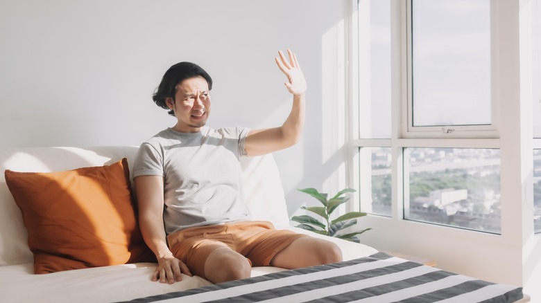man blocking out sunlight 