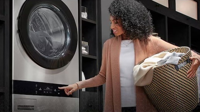 Woman using an LG Studio washing machine