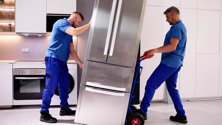 Men installing a new refrigerator