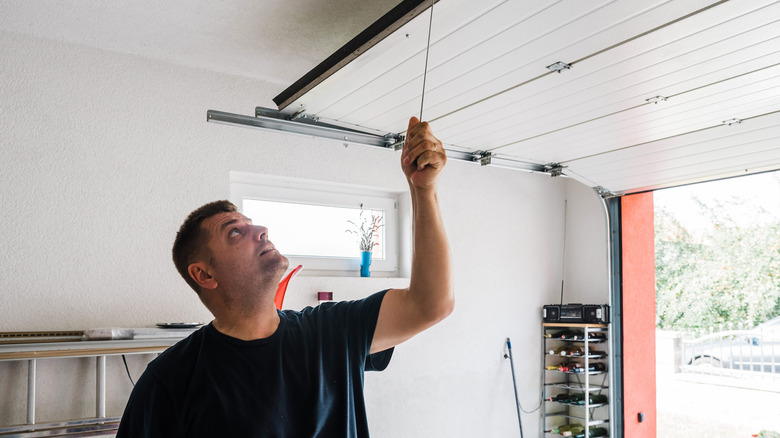 man looking at garage ceiling