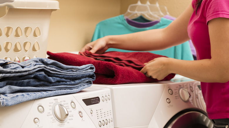 woman folding clothes on machines