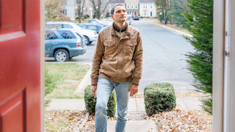 Man walking into open home