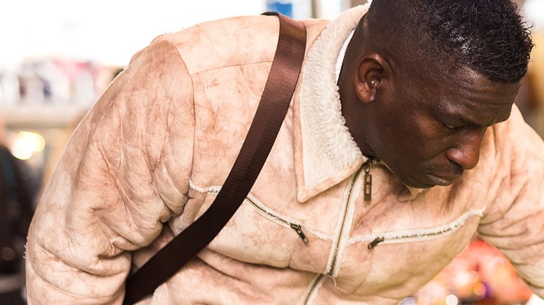 Person looks at items for sale displayed on a table at a flea market