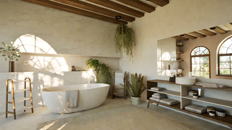 Photo of warm-looking bathroom with tub, plants, and wood accents
