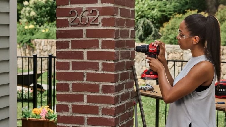 Woman using a Craftsman power drill