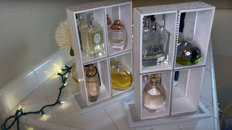 two white perfume display shelves