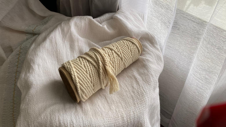 Roll of macrame on a white cloth