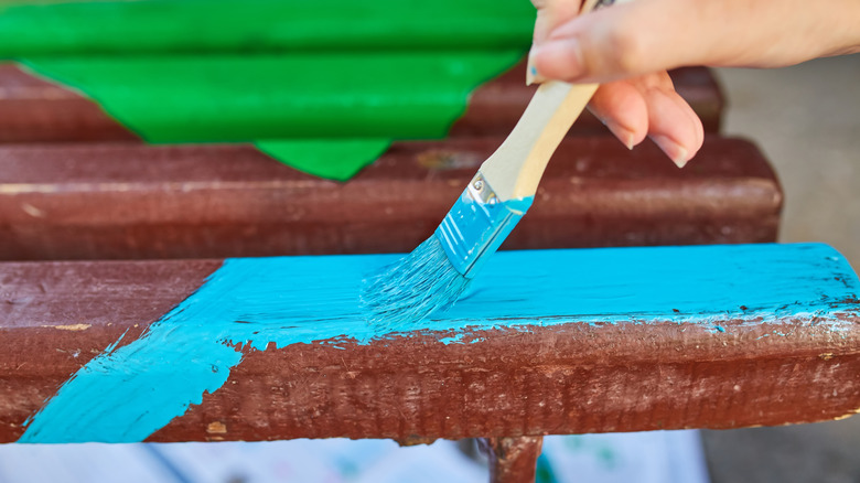 Hand painting a bench