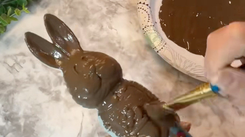 woman painting bunny figurine brown