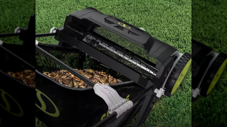 Sun Joe Lawn Sweeper partially filled with leaves
