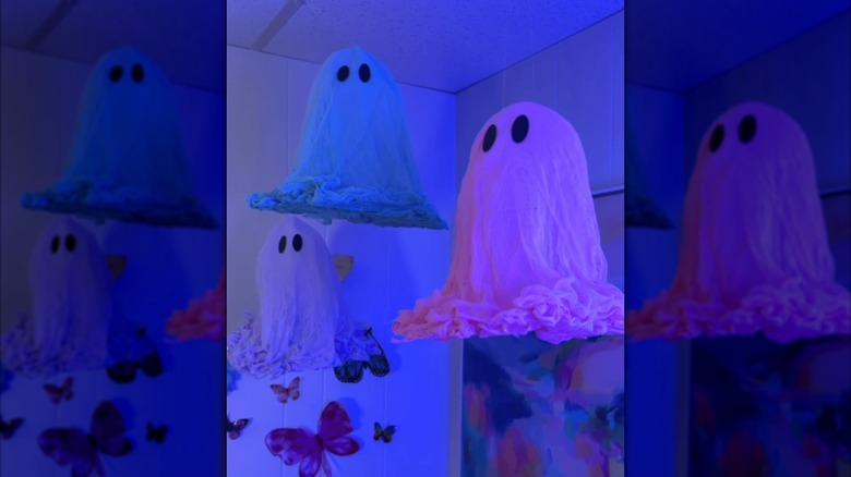Hanging Halloween ghost decorations made from colored cheesecloth
