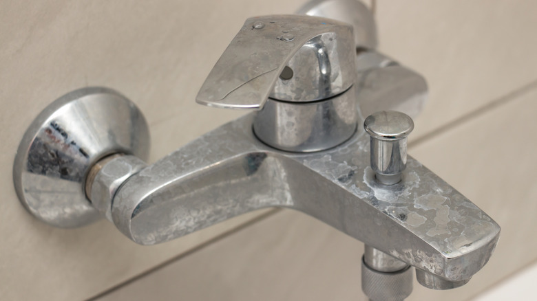 A shower faucet with limescale buildup