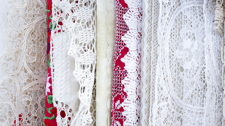 A selection of lace tablecloths at a thrift store