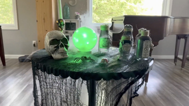 A DIY fortune teller crystal ball made using a snow globe, lights, and tulle