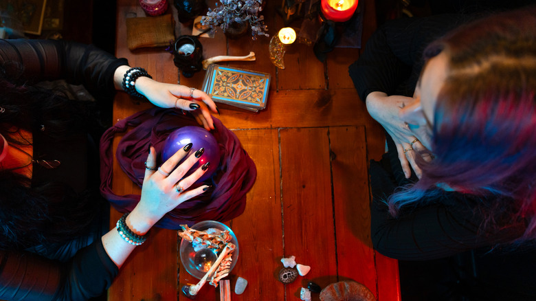 Halloween setting with fortune tellers' crystal ball and tarot cards