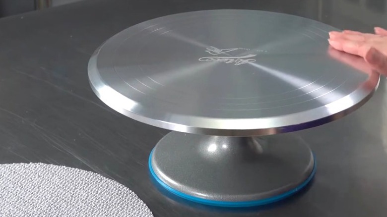 Person showing off rotating cake stand to use as spray paint turntable