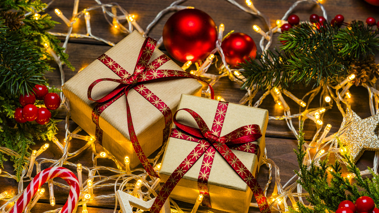 Rows of white lights surrounding two wrapped presents, their ribbons featuring red with gold glittery stars