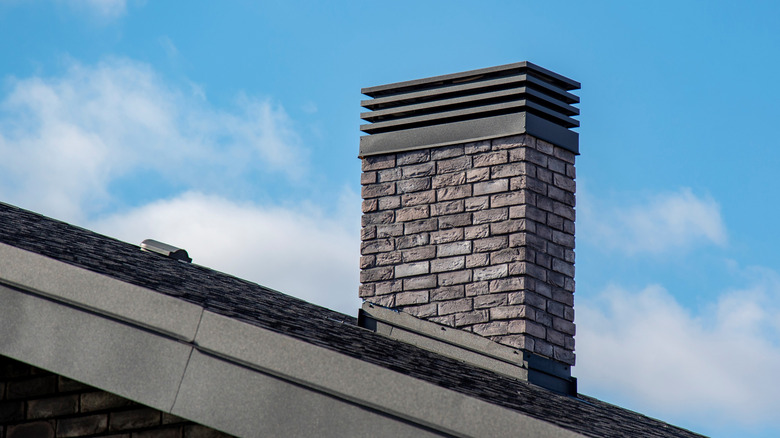 Brick chimney extending from the roof of a home