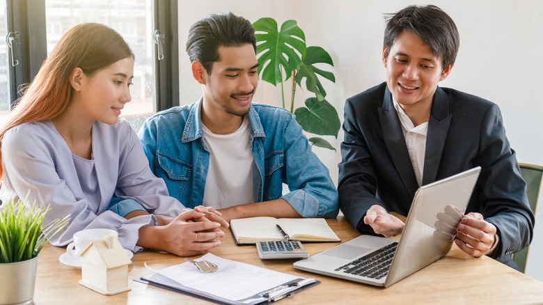 Young couple with realtor