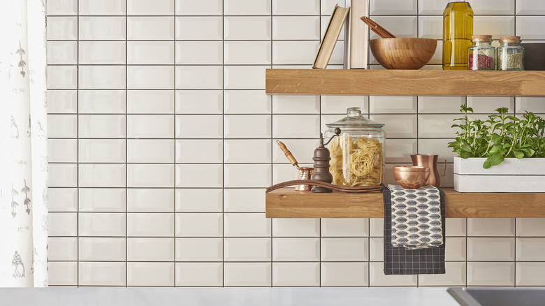 A kitchen featuring a set of open shelves.
