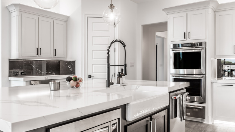 The interior of an all-white kitchen.