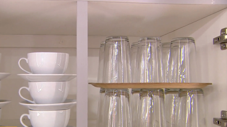 Martha Stewart demonstrates how she stacks trays on top of cups to add more storage.