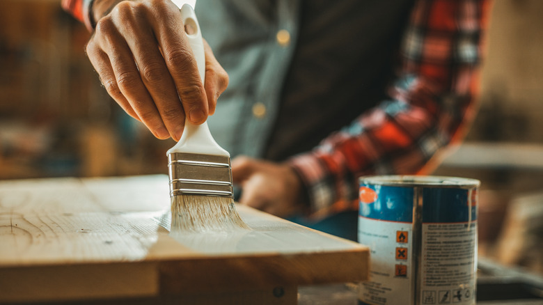 man applying wood stain