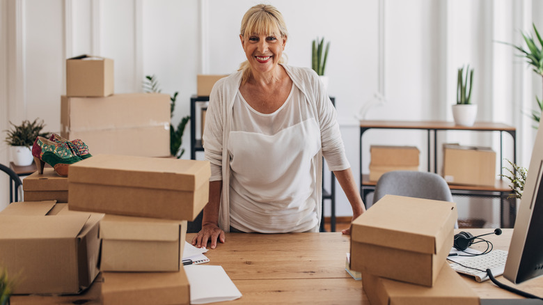 woman surrounded by shoe boxes