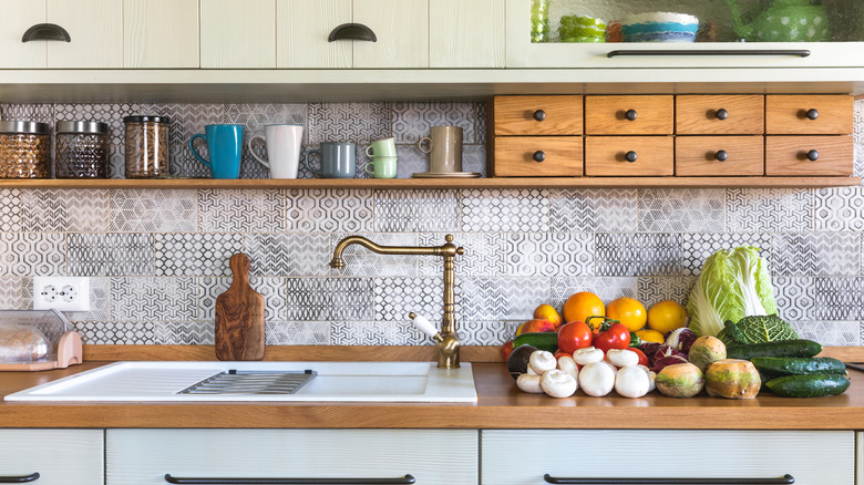 Kitchen with small wood apothecary-style drawers beneath upper cabinets
