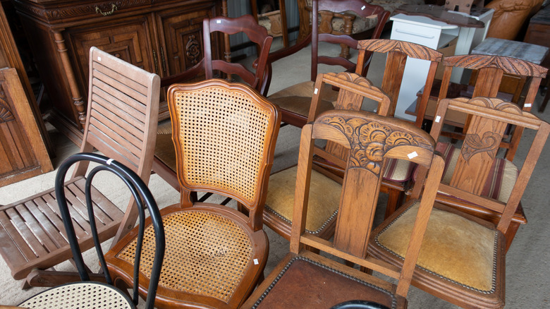 Rows of wooden dining chairs on a store floor collecting dust