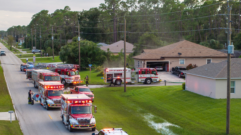 Fire engines and first responders parked outside of a house