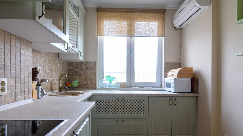 A kitchen with an outside-mounted roll-up blind