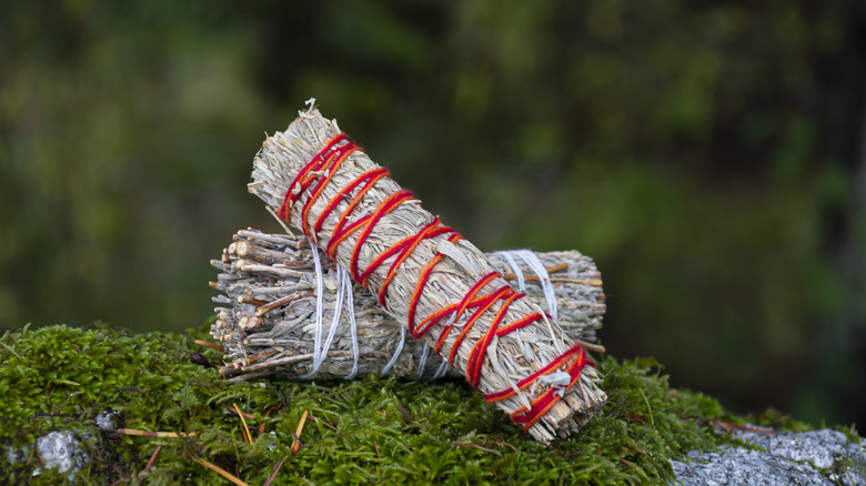 Two sage sticks with colorful string